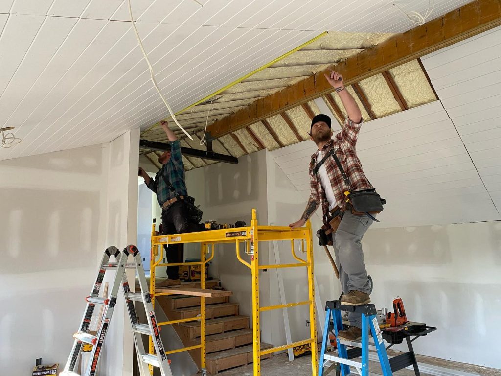 Katz Construction Team Photo applying ceiling